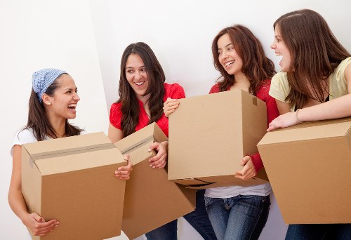 Expert moving team handling packing boxes in West Hampstead
