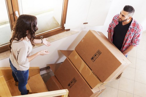 Business professionals planning a move with blueprints and digital tools