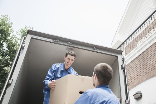 Professionals carefully packing household items during a move